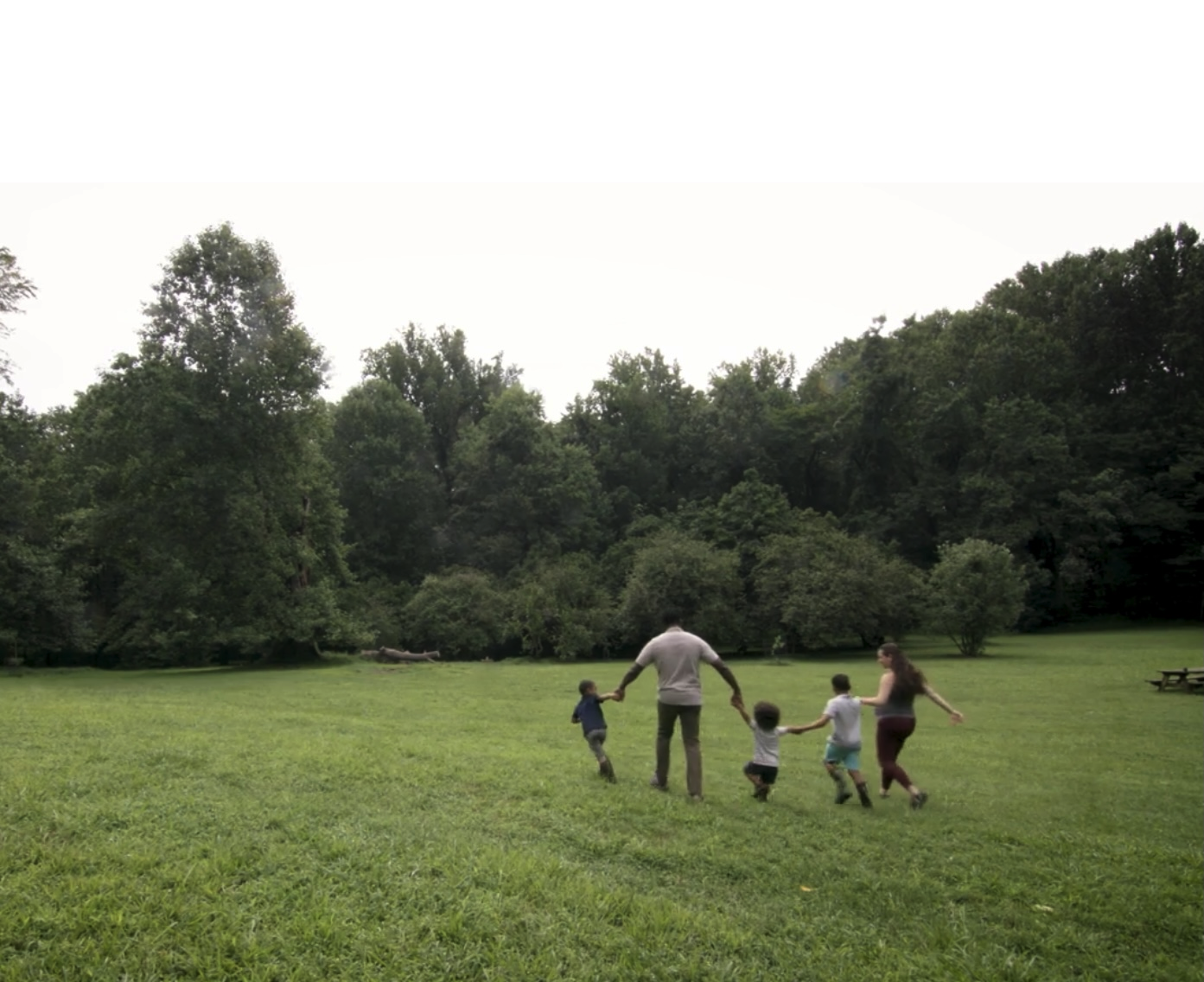 A family walking through a meadow at Gwynns Falls-Leakin Park.