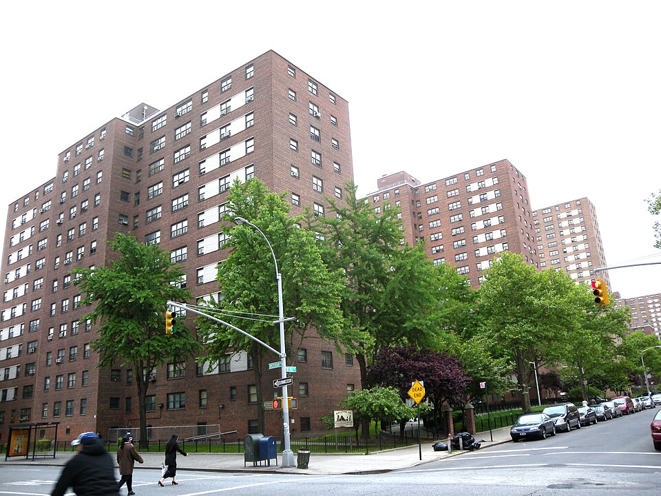 Looking east across Amsterdam Avenue and 102nd Street at Frederick Douglass Houses on a cloudy late afternoon.